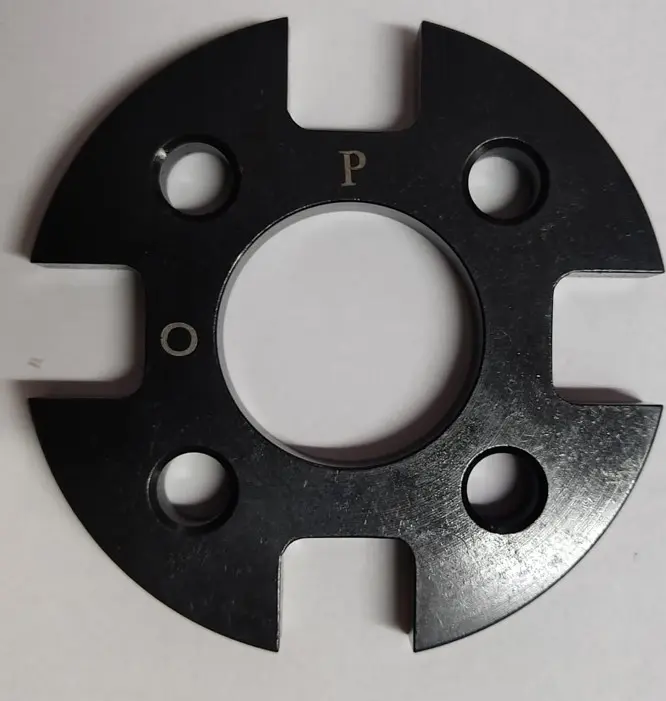 A black metal spacer and coupler component with multiple holes and 'P' and 'O' markings, displayed on a white background.